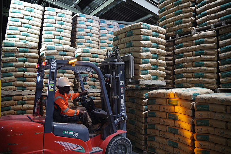 A forklift operator loading cement for transport